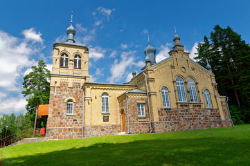 Fototapeta na wymiar Old orthodox church with domes, built of bricks.