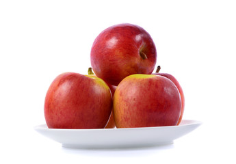 red apple in white plate isolated on white background