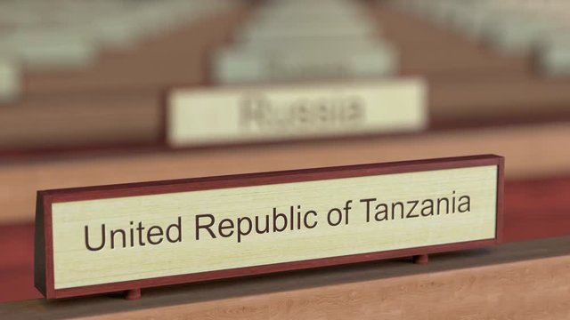 United Republic of Tanzania name sign among different countries plaques at international organization. 3D rendering