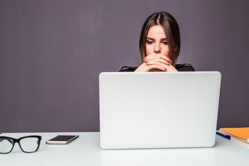 Woman over laptop working and planning work thinking concept in office