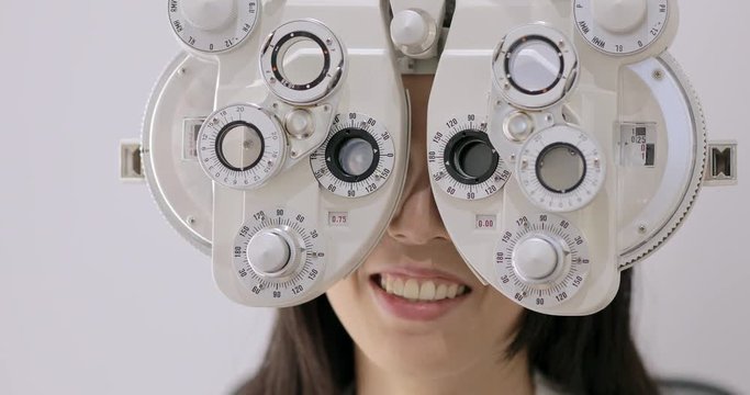 Asian woman having eye test