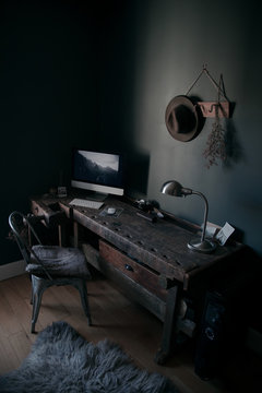 Desktop computer with lamp on wooden table