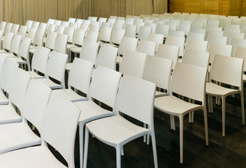 White chairs seats in conference room lecture audience or presentation hall
