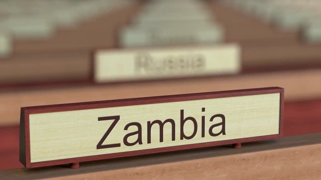 Zambia name sign among different countries plaques at international organization. 3D rendering