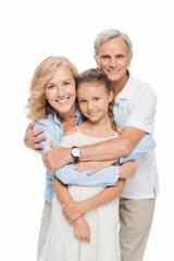 grandparents with grandchild hugging