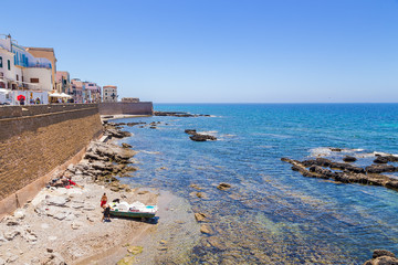 Alghero, Sardinia, Italy. The picturesque embankment and ancient bastions on the shore of the bay