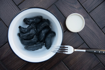 Black Russian dumplings vareniki in bowl