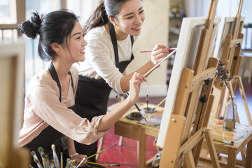 Young women learning painting in art class