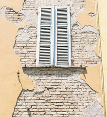 Closed Window on the Dilapidated Facade of the Old Italian House. Vintage effect.