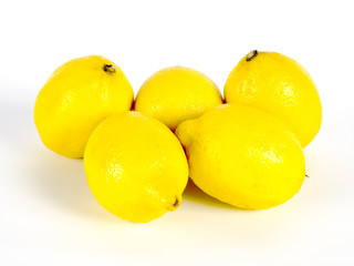 Yellow lemon with fresh green leaves over white background