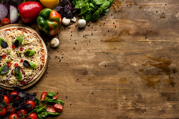 raw homemade pizza with ingredients