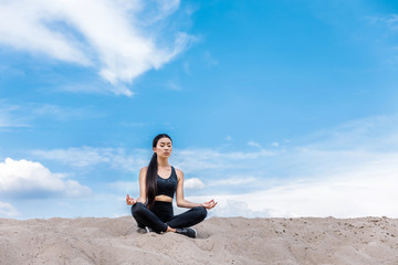 Fototapeta na wymiar woman meditating in lotus yoga pose