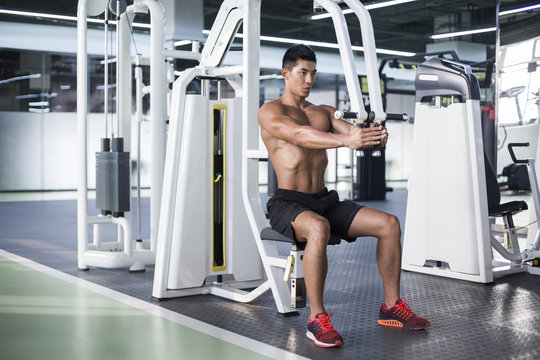 Young man exercising at gym