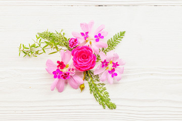 Festive flower composition on the white wooden background. Overhead view.
