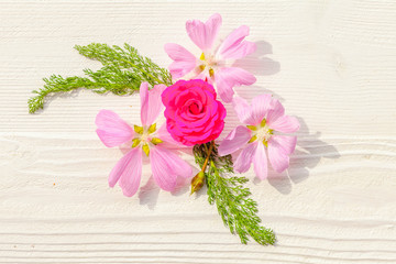 Festive flower composition on the white wooden background. Overhead view.
