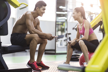 Young couple talking in the gym