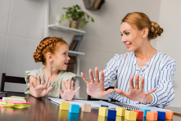 mother and daughter learning math at home