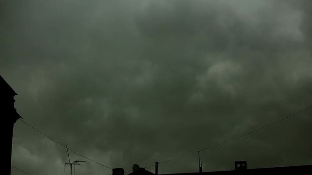 Gray clouds thicken over the city. They are like steam or fog. The sky is not visible. Tamelaps.