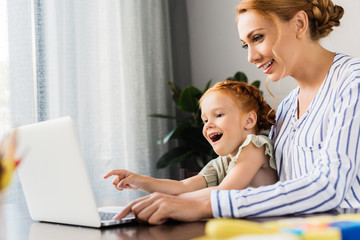 mother and daughter using laptop