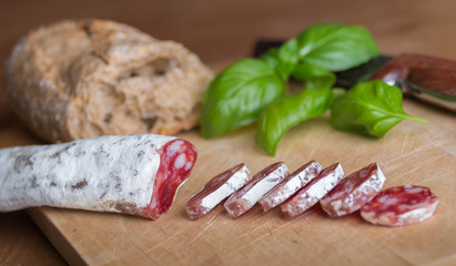 italian salami with herbs on a cutting board