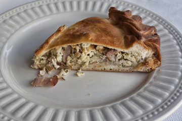 A piece of pie with ham