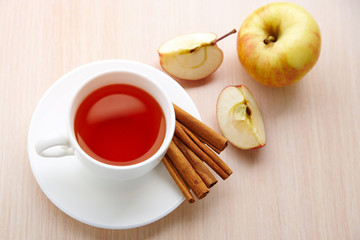 A cup of tea with apple and cinnamon top view