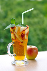 A glass of apple drink with mint