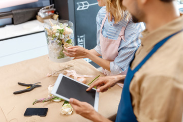 florists working with digital devices