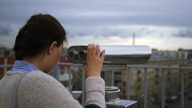 Consider the houses and streets of the city in a telescope. slow motion, 1920x1080, full hd