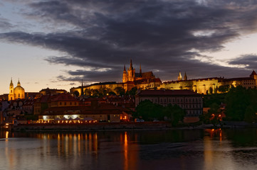 Fototapeta na wymiar Czech Republic, Prague, Night view on Hradcany castle.Beautifully lit castle and Vltava river in the foreground.