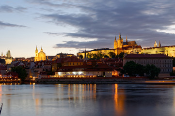 Fototapeta na wymiar Czech Republic, Prague, Night view on Hradcany castle.Beautifully lit castle and Vltava river in the foreground.