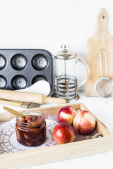 Nectarine jam in a jar next to fresh fruits