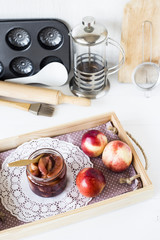 Nectarine jam in a jar next to fresh fruits