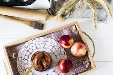 Nectarine jam in a jar next to fresh fruits