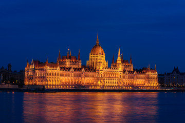 Fototapeta na wymiar Budapest Parliament building and Danube river at night with illumination, travel sightseeing background