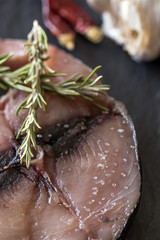 Raw tuna steak on plate and wooden table