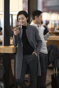 Business people using smart phones