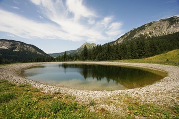 Alpine landscape with storage pond 
