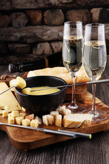 Gourmet Swiss fondue dinner on a winter evening with assorted ch