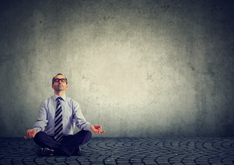 Business man meditating relaxing with eyes closed