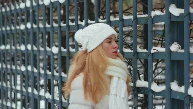 Beautiful young woman walking on a clear winter day. Winter walk