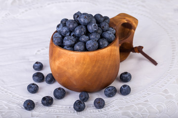 Piles of Blueberries and blackberries in Kuksa Ancient Lapland Finland Wooden Drinking Cup