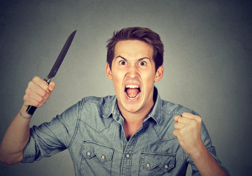 Angry aggressive man with knife