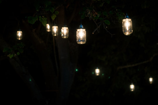 Vintage lightbulbs hanging from a tree. Retro toned.Copyspace included.