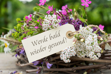 Get better soon / Greeting card with colorful bouquet and german text: Get better soon 