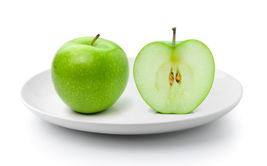 green apple in a plate isolated on a white background