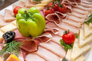 Catering food with cherry tomatoes, ham, and salami