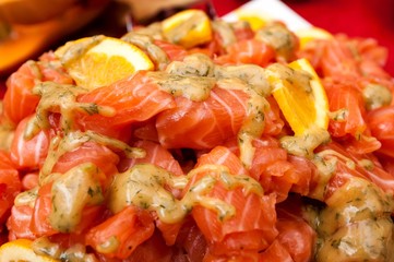 Fresh salmon salad served on a wide plate on a table