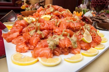 Fresh salmon salad served on a wide plate on a table
