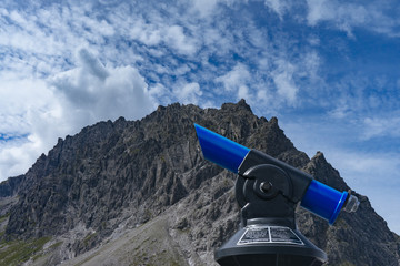 Fototapeta na wymiar telescope in front of mountain in the alps